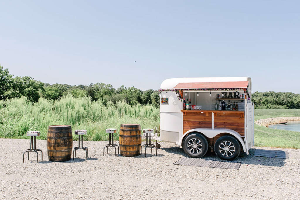 A white traveling bar designed from an enclosed trailer.
